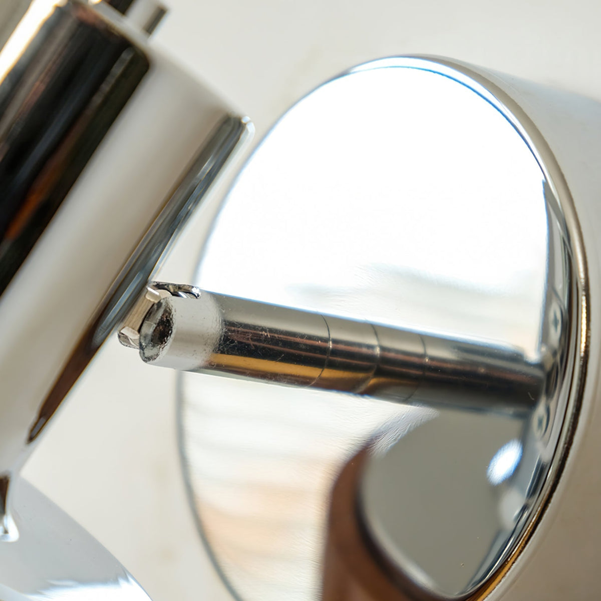 Karrivelle Wall Light, close-up of chrome swivel arm and backplate