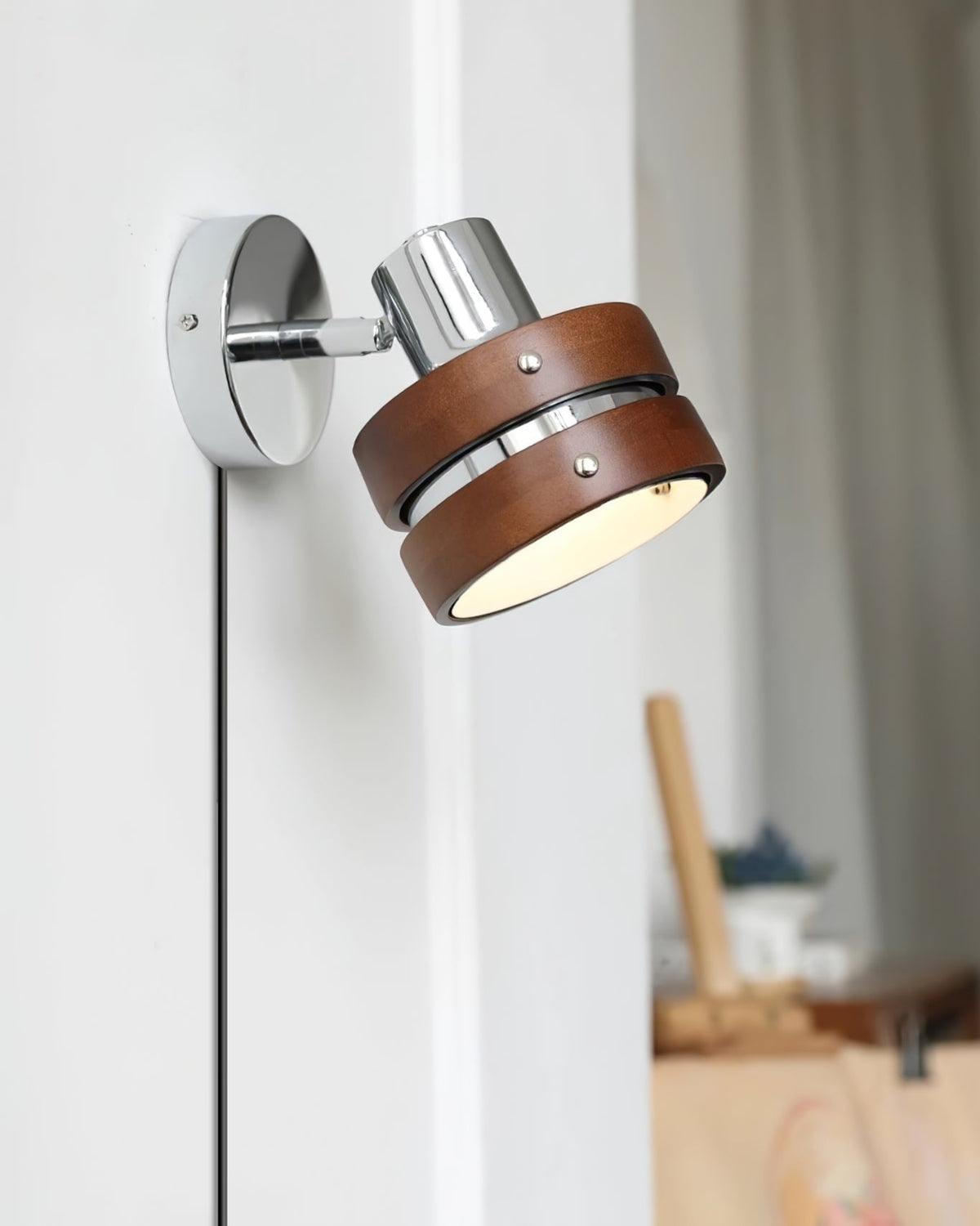 Karrivelle Wall Light, angled view lit on a white wall