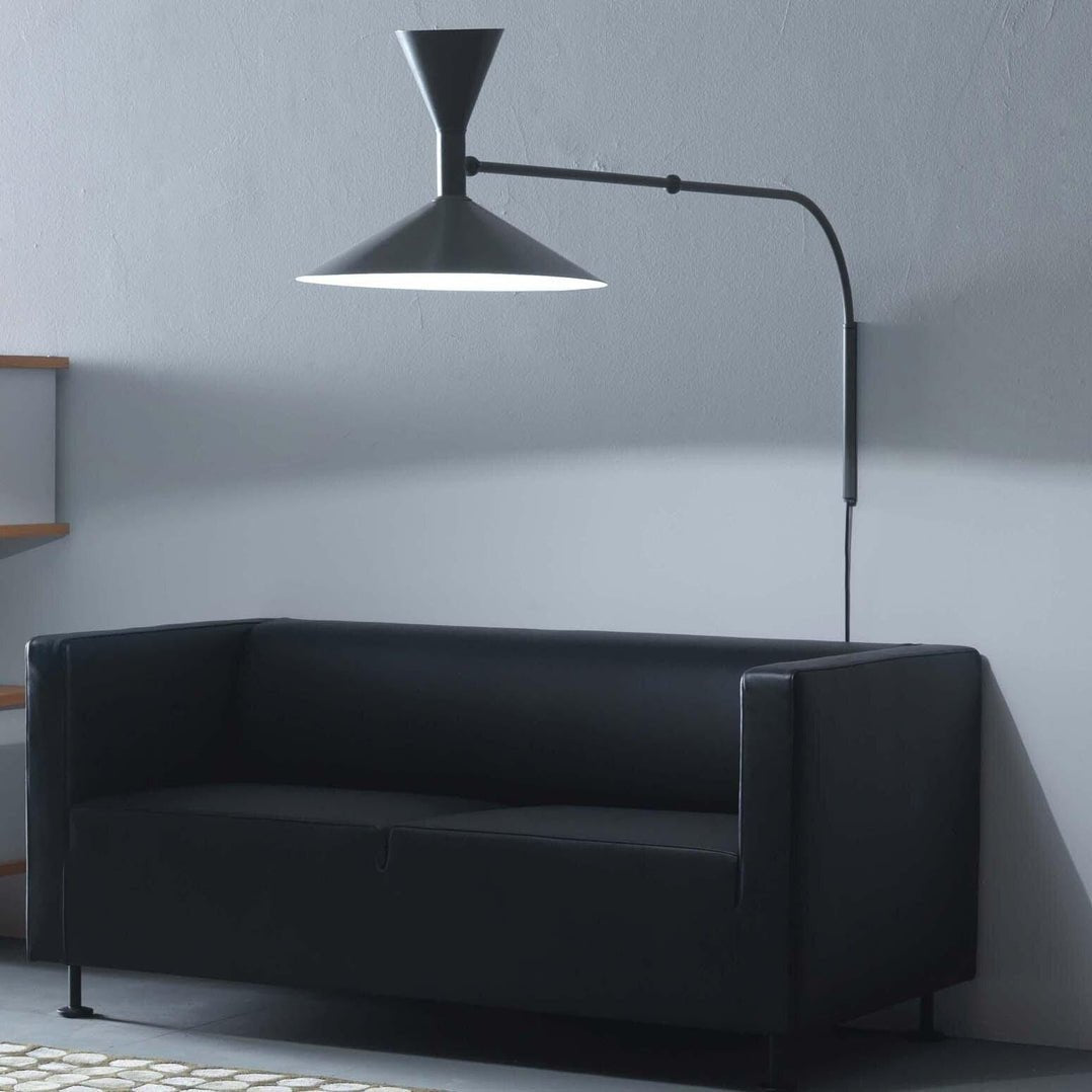 Marsellin Wall Light in black, extended above a leather sofa