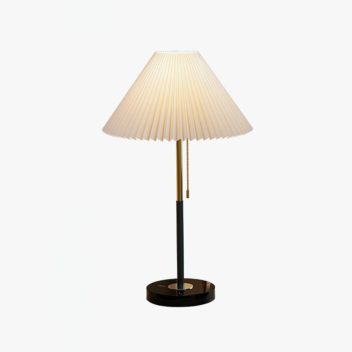 Mathella Table Lamp in white with pleated shade, brass-and-black stem and round black base on a plain background