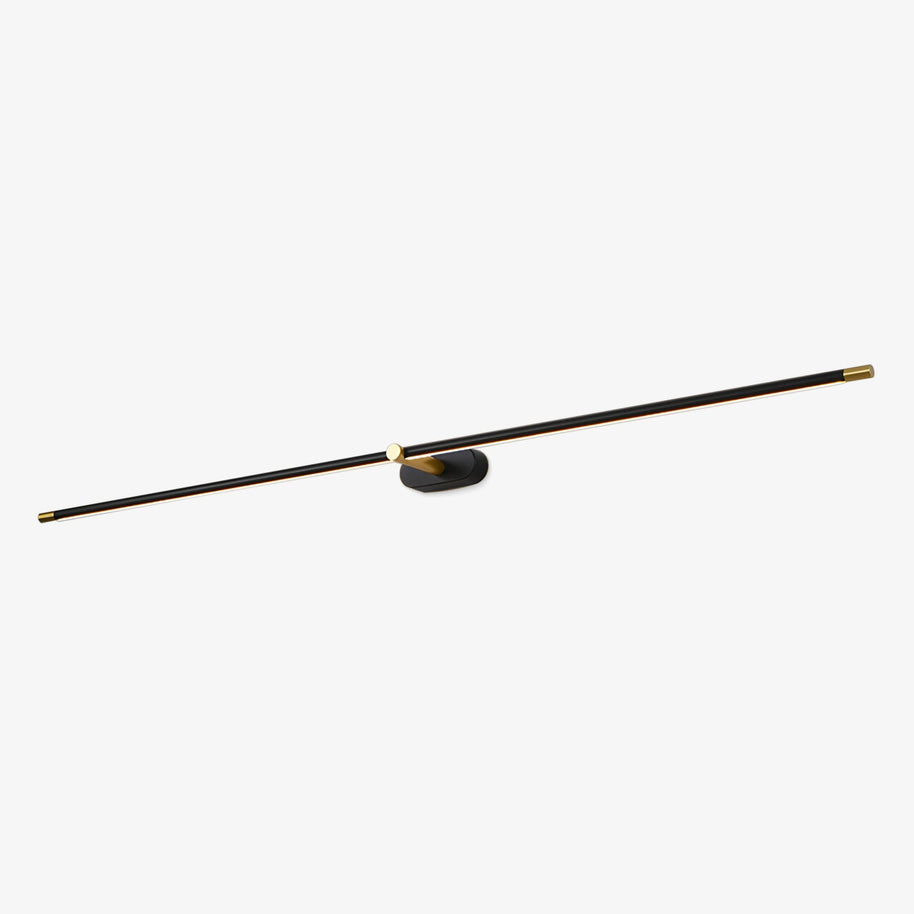 Black and gold slim linear LED wall light on an oval wall plate, angled studio view on a plain white background