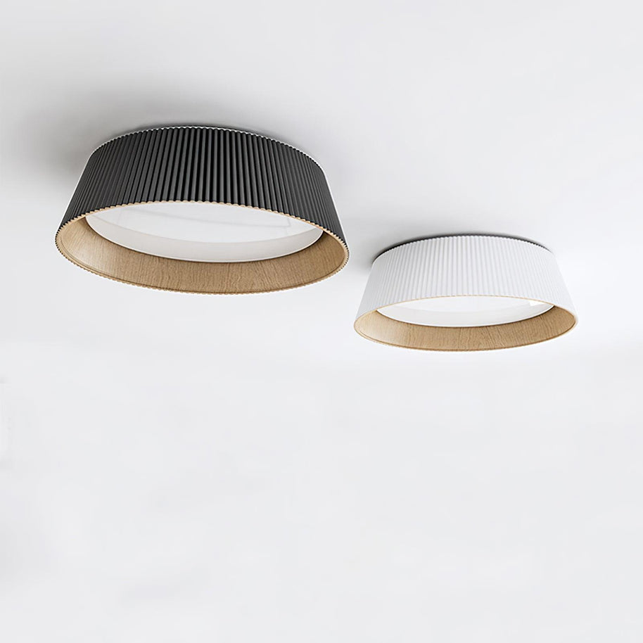 The black and the white ceiling lights side by side on a white ceiling.