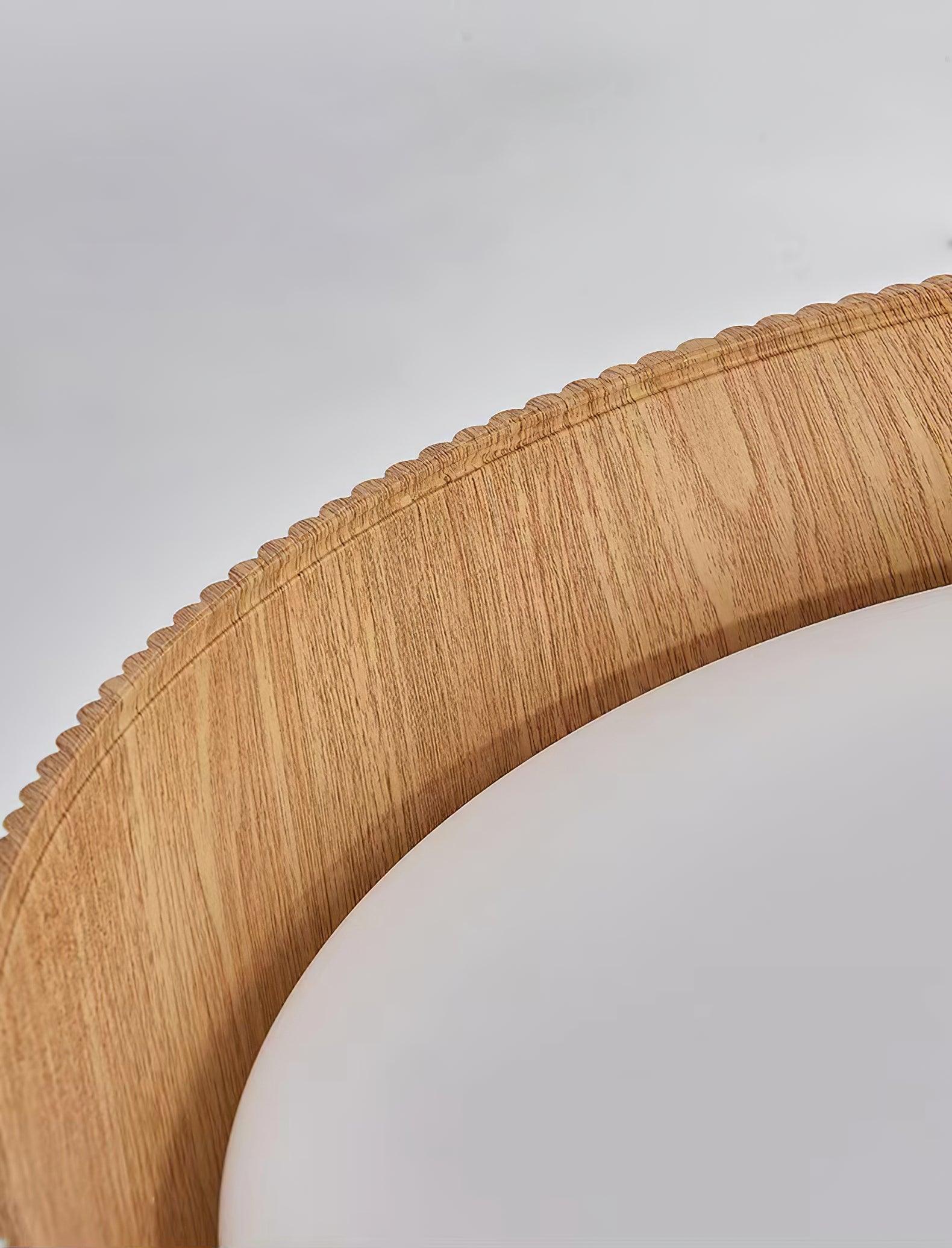 Close view of the wood-look inner rim meeting the white diffuser.