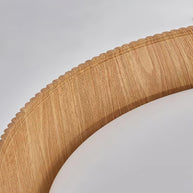 Close view of the wood-look inner rim meeting the white diffuser.