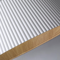 Close view of the ribbed white outer surface and the wood-look rim.