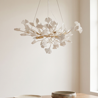 Gilded Ginkgo Leaf Chandelier shown at scale above a set dining table