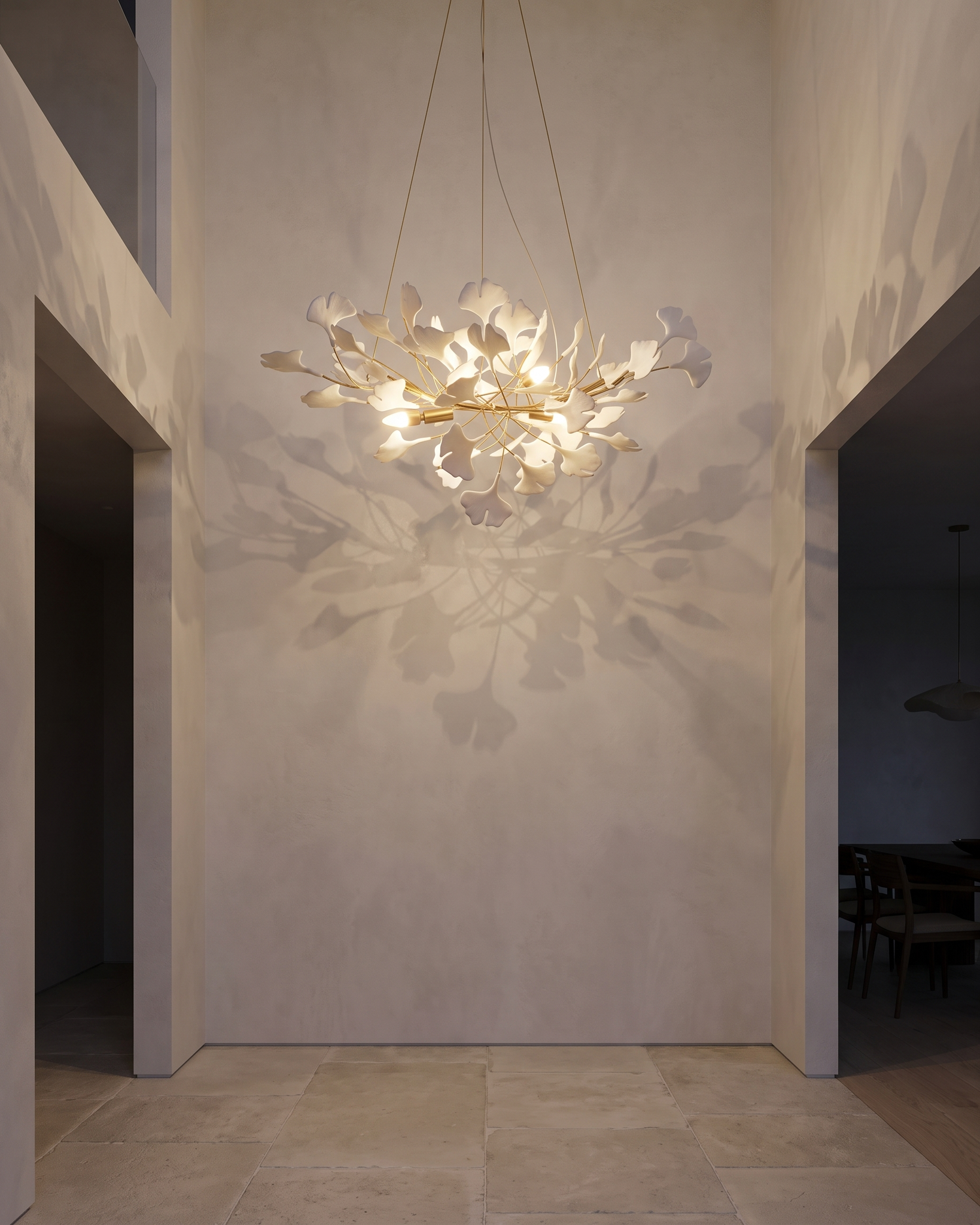 Gilded Ginkgo Leaf Chandelier in an entryway landing at dusk