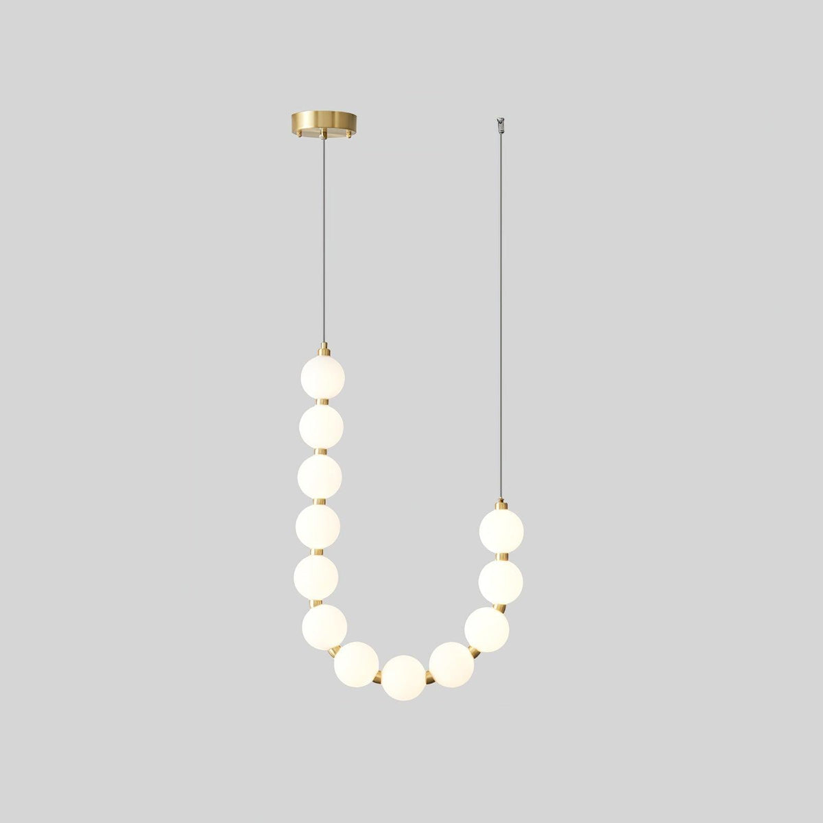 Perloria Chandelier, single U-shaped strand of opal white glass globes with brass collars and round canopy