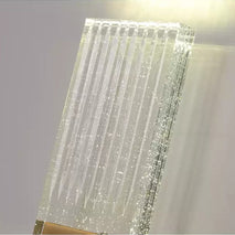Close view of the ribbed glass panel showing the bubbles inside it.