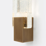 Close view of the brass mount holding the ribbed glass panel.