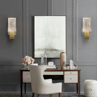 Two of the wall lights either side of a mirror above a desk.