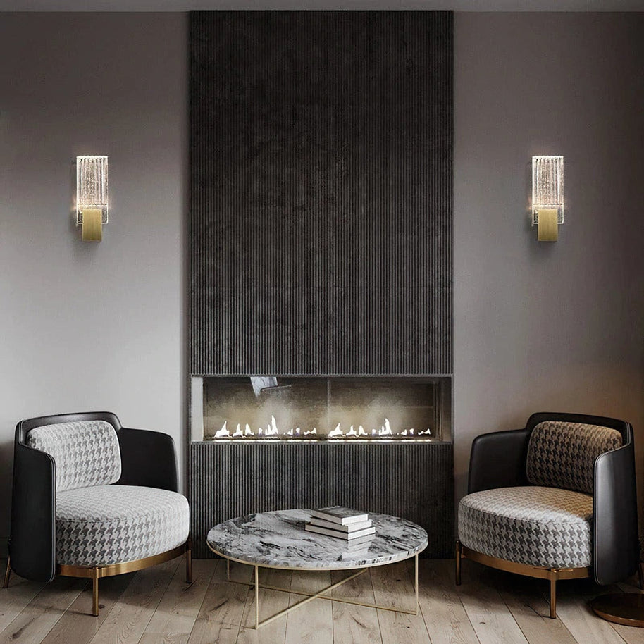 Two of the wall lights lit either side of a fireplace.