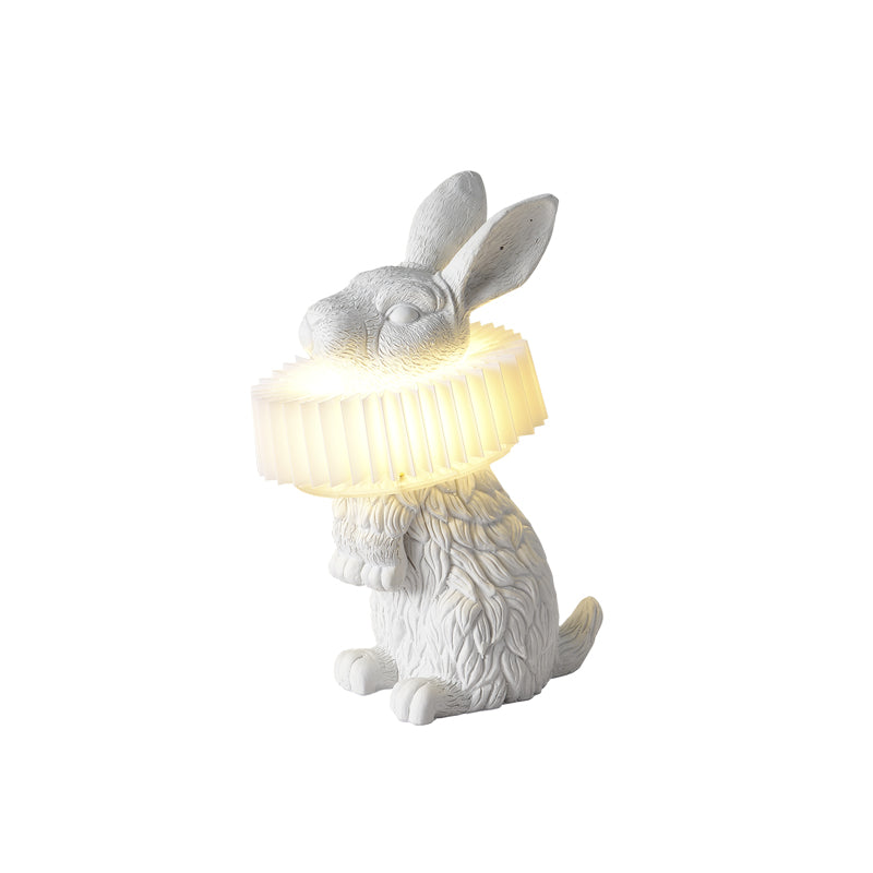 Rabellin Table Lamp - standing white leaf-textured rabbit with pleated ruff shade glowing warm, white background