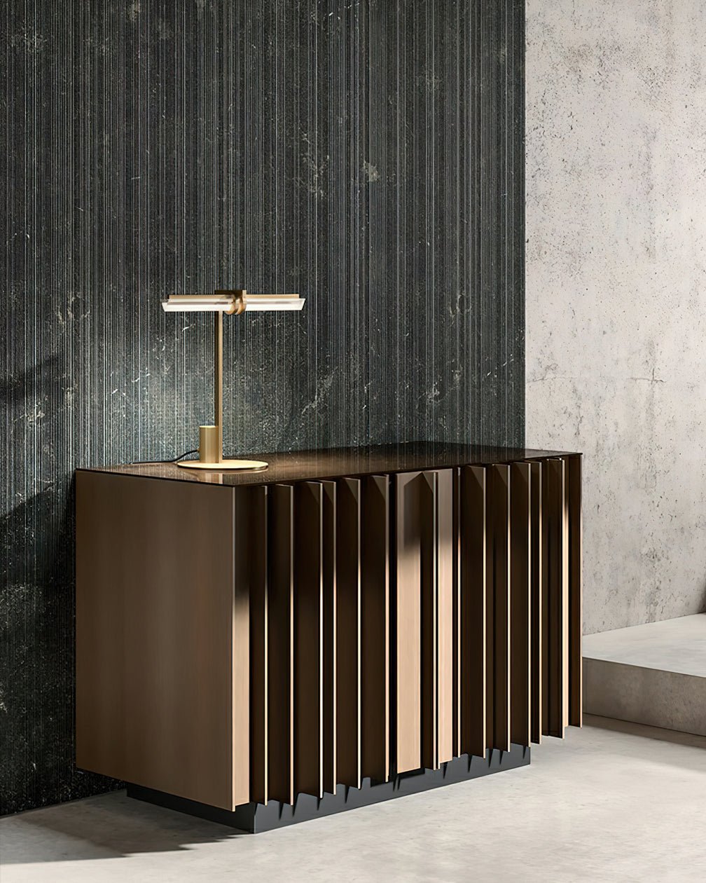 Revalyn Table Lamp in brass with glass linear bar on a fluted bronze cabinet in a concrete room