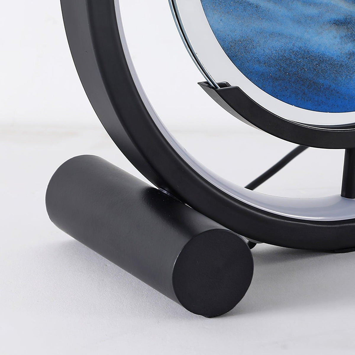 Sandrelle Table Lamp in black, close-up of the cylinder foot, ring base and cradle holding the sand panel