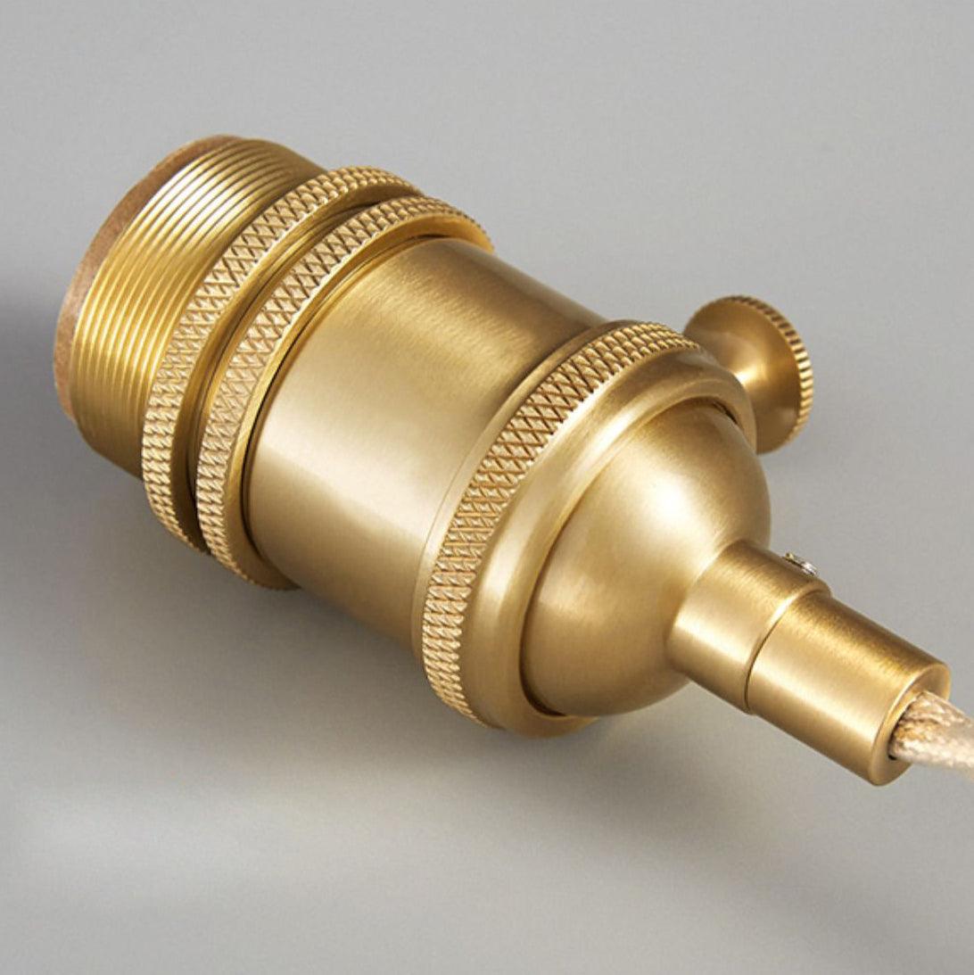 Close view of the gold-toned lamp holder and its knurled collar and switch.