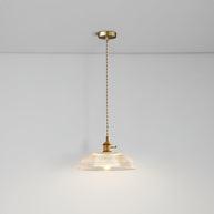 Pendant light with a ribbed glass dome shade and a gold-toned lamp holder hanging from a ceiling rose on a twisted fabric cable, lit softly.