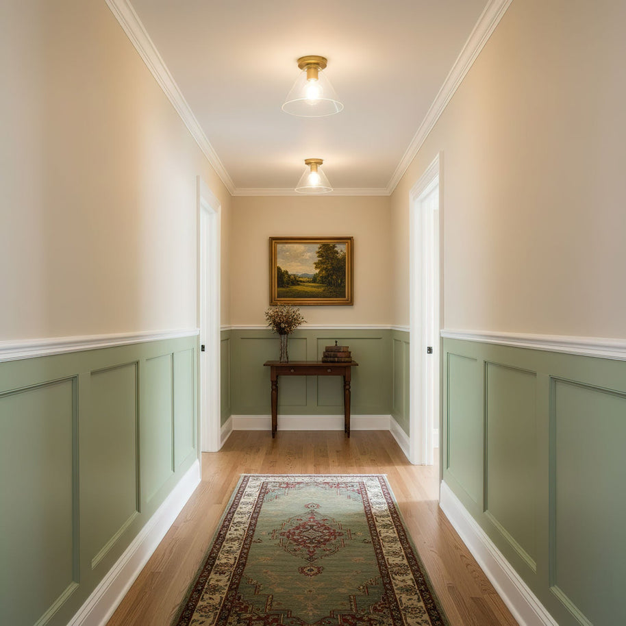 Two of the ceiling lights fitted along a hallway with green panelled walls.