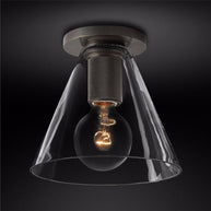 Flush-mount ceiling light with a dark ceiling plate, knurled holder and a clear cone-shaped glass shade.
