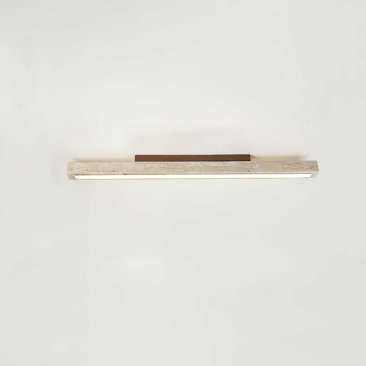 Travellin Ceiling Light, travertine bar with dark walnut mount on a pale ceiling