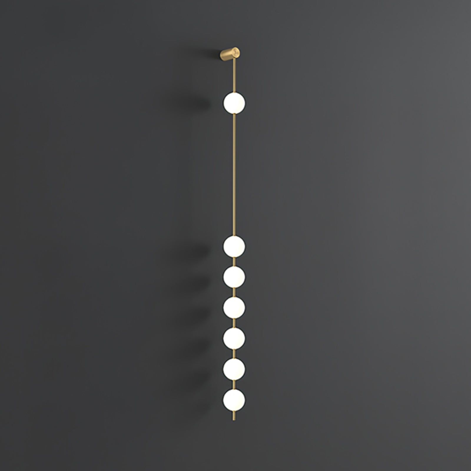 Wall lamp with a vertical row of white ball shades on a slim brass-coloured rod, unlit, on a grey wall, with a longer row of shades.