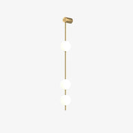 Wall lamp with a vertical row of white ball shades on a slim gold-toned rod, unlit, photographed against white.