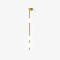 Wall lamp with a vertical row of white ball shades on a slim gold-toned rod, unlit, on a white background with a soft shadow.