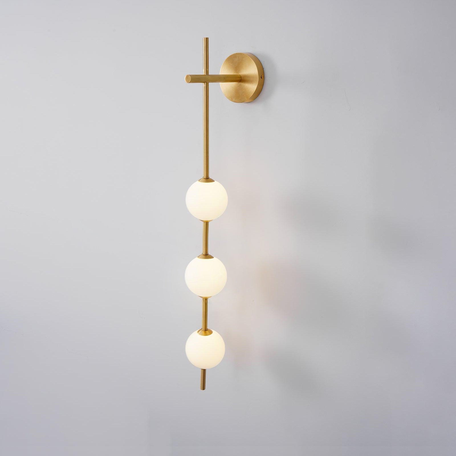 Solenne Vertical Globe Wall Light in Brass, 3.9 in dia x H 30.7 in - Comvilo lighting