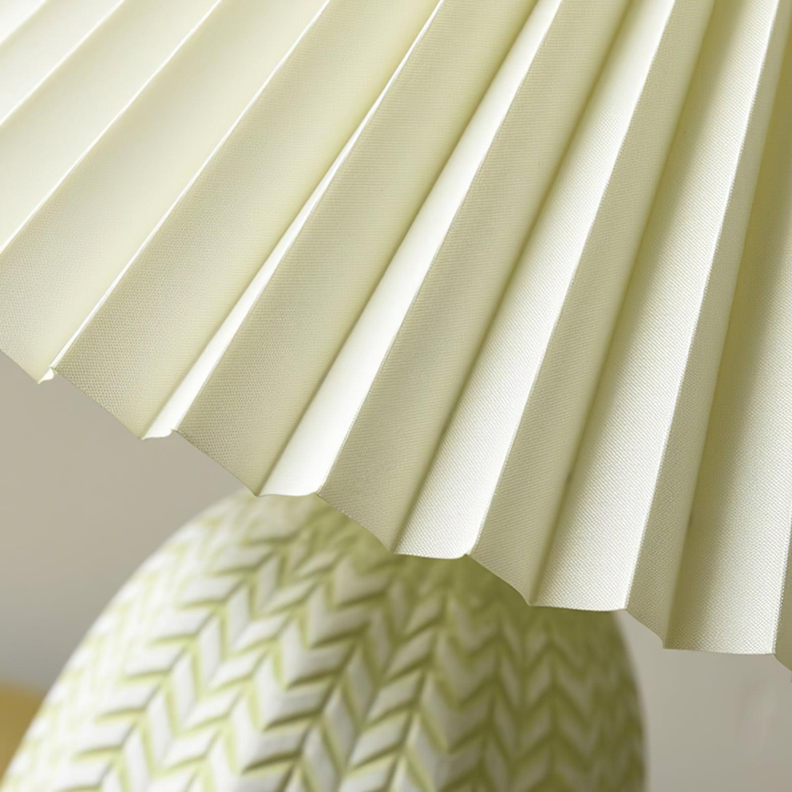 Close view of the cream pleats meeting the chevron-patterned base.