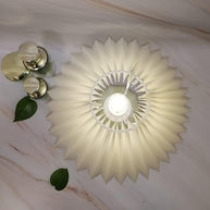 The plain cream shade seen from directly above, lit.