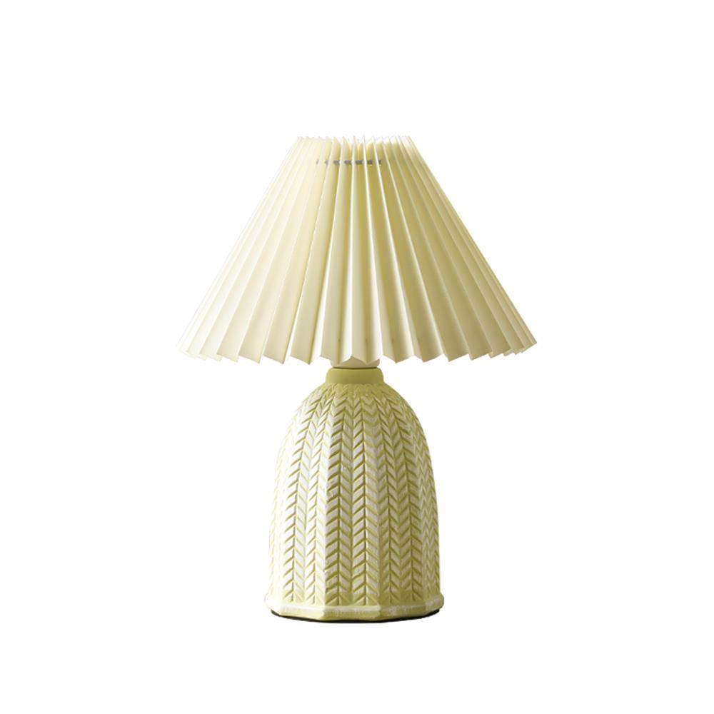 Table lamp with a plain cream pleated shade and a pale green ceramic base with a raised chevron pattern, shown on a white background.