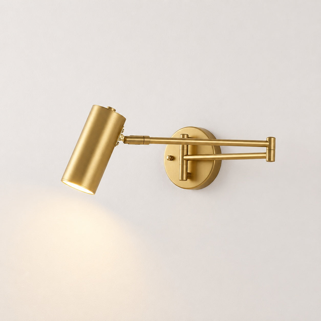 Marlow Arc Swing Wall Sconce - lit studio image on white background for Comvilo lighting