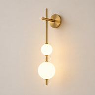 Solenne Vertical Globe Wall Light - lit studio image on white background for Comvilo lighting