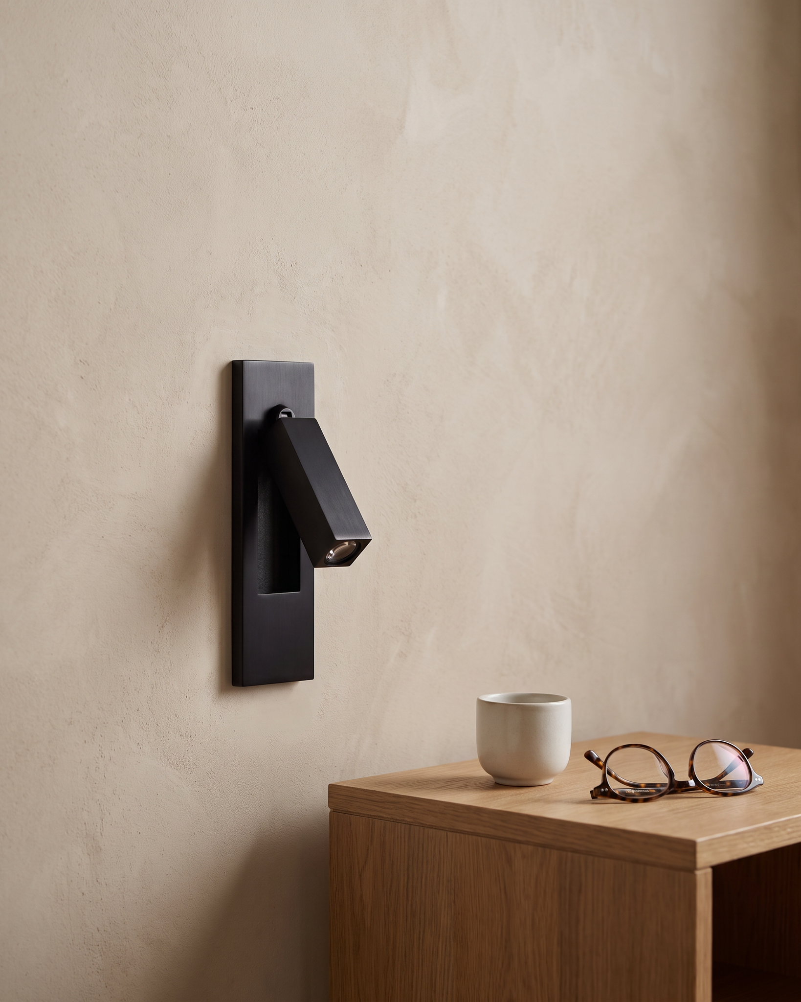 Valen Recessed Bedside Wall Sconce shown at scale beside a bedside table