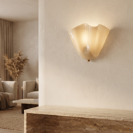 Vela Ribbed Glass Wall Lamp installed above a console in a living room
