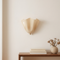Vela Ribbed Glass Wall Lamp shown at scale above a console table