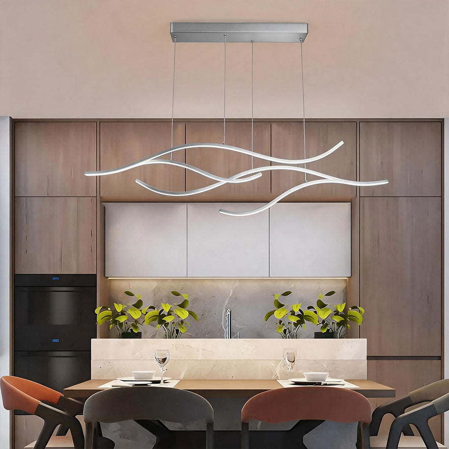Linear pendant light made of wavy chrome-coloured LED bars hung from a slim rectangular canopy above a dining table in a wood-panelled room.