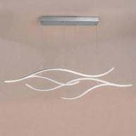 Linear pendant light made of wavy chrome-coloured LED bars hung from a slim rectangular canopy, lit, shown against a plain wall.