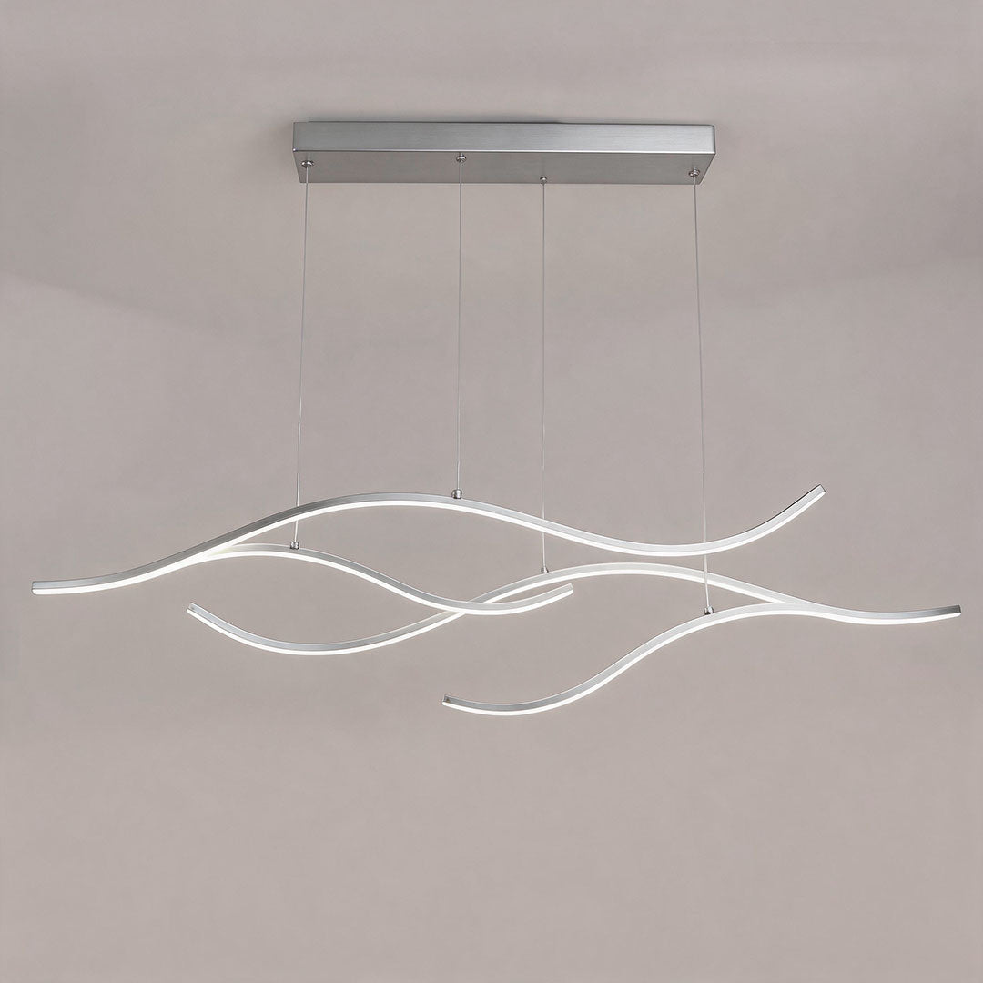 Linear pendant light made of wavy chrome-coloured LED bars hung from a slim rectangular canopy, lit, shown against a plain wall.