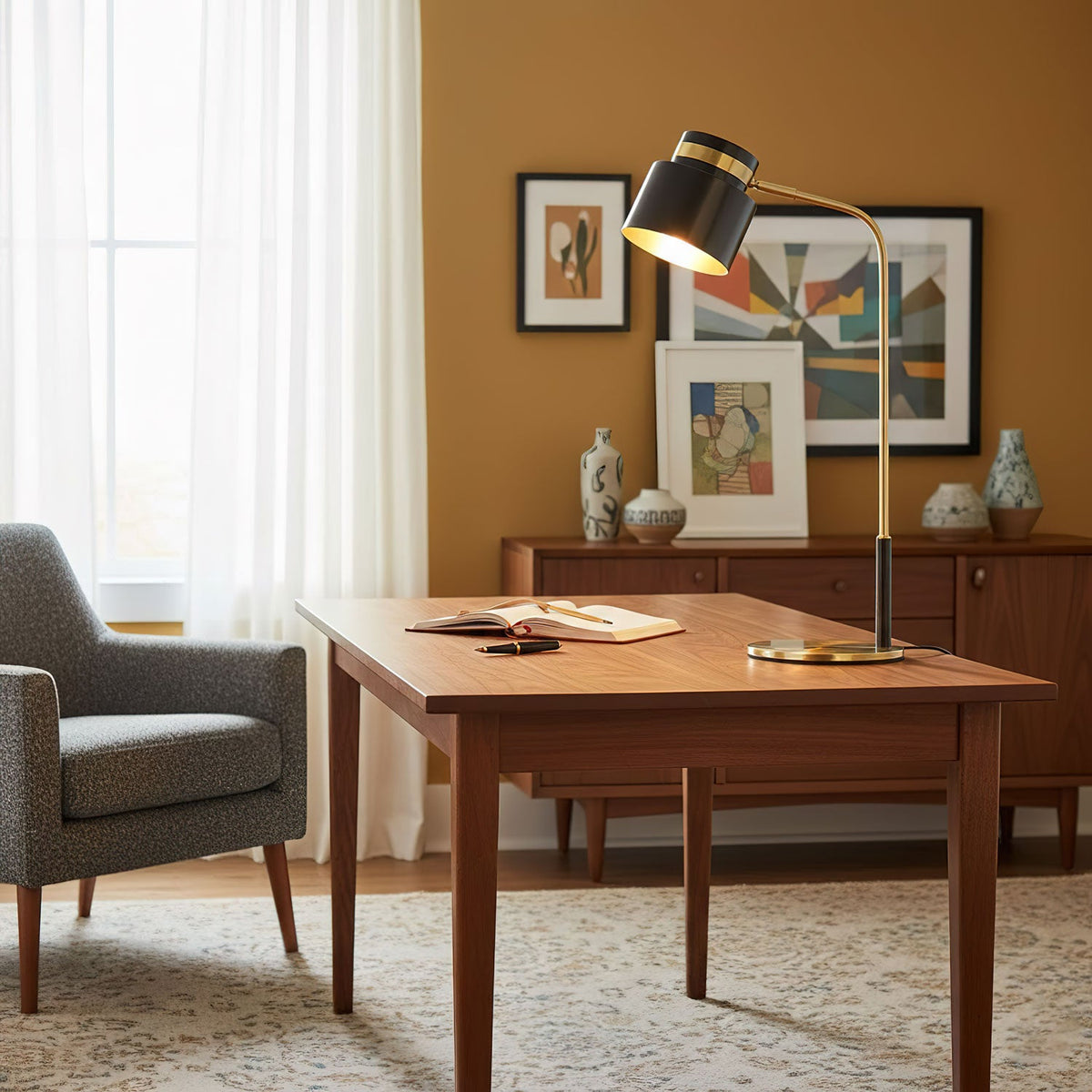 Ardin Table Lamp on a wooden desk in a room with a mustard wall