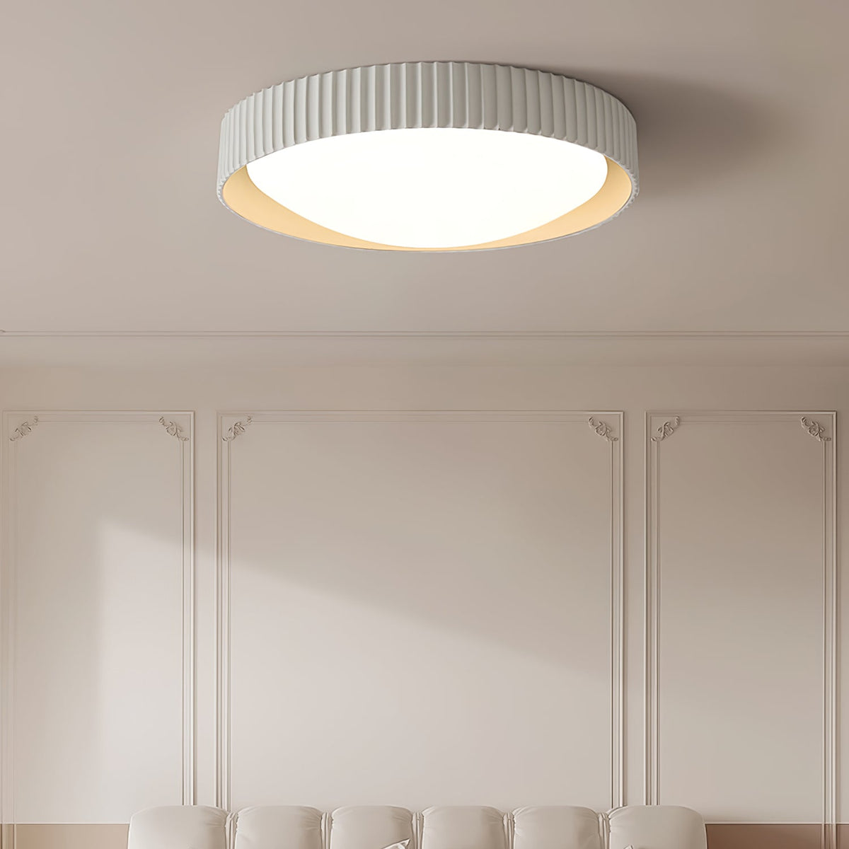 Avelune Ceiling Light with light grey ribbed frame, lit, on a ceiling above a paneled wall and sofa