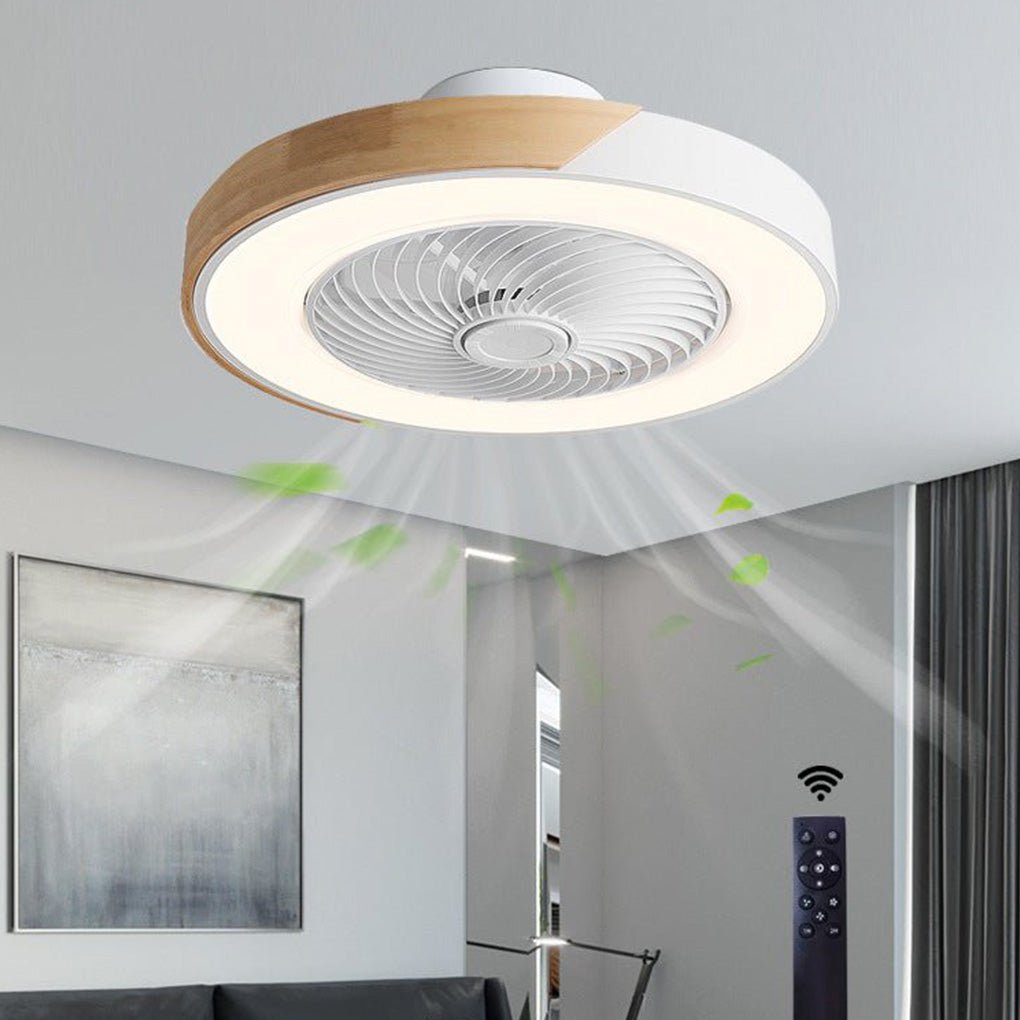 Round white and wood-grain bladeless ceiling fan with light on a living-room ceiling, shown with its remote and drawn airflow.