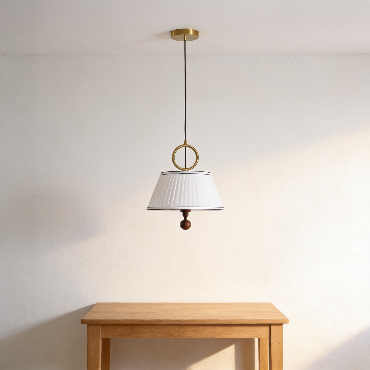 Alivora Pendant Light, white pleated shade with brass ring and walnut finial above a table