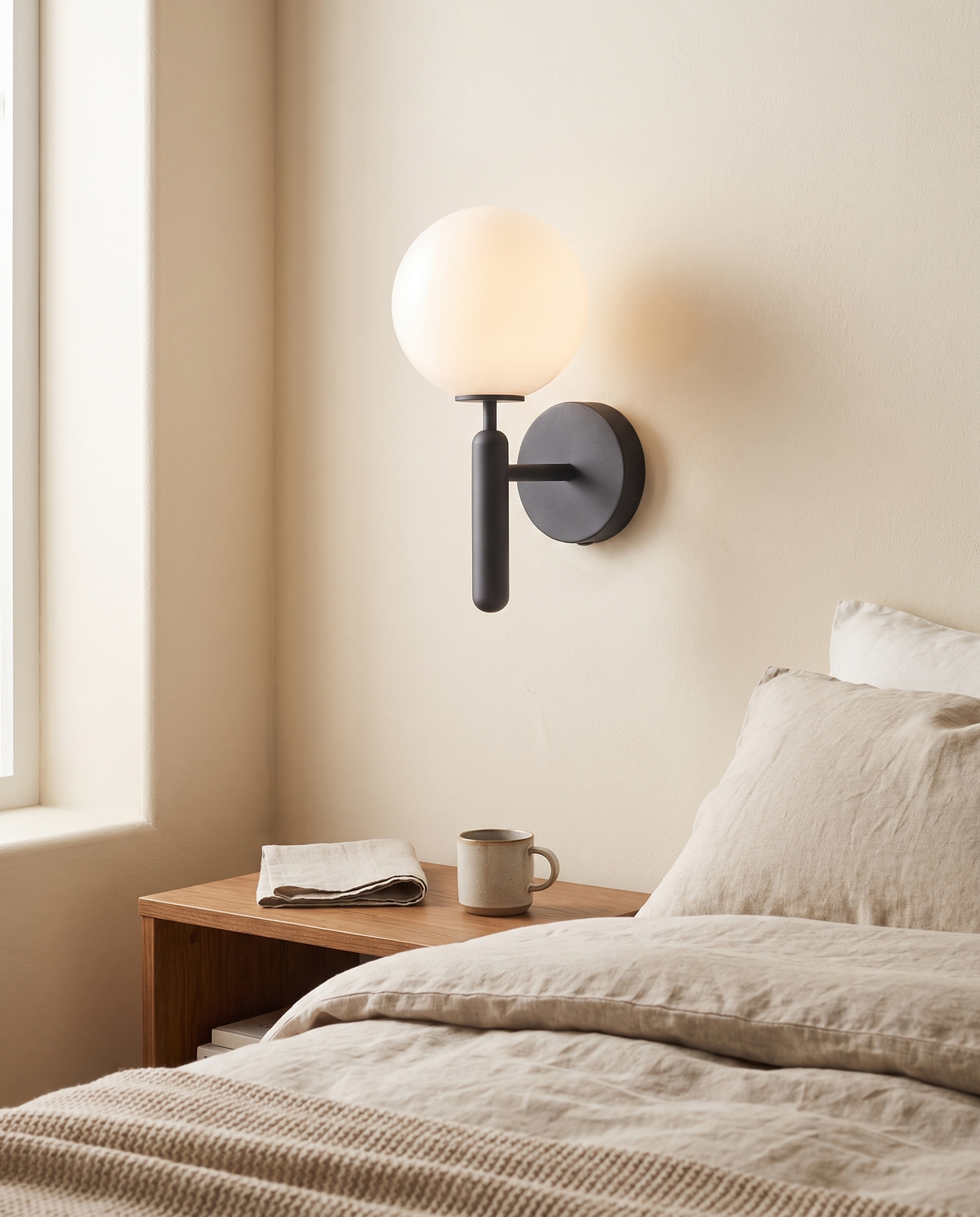 Orvella Globe Wall Light in a bedroom in soft daylight