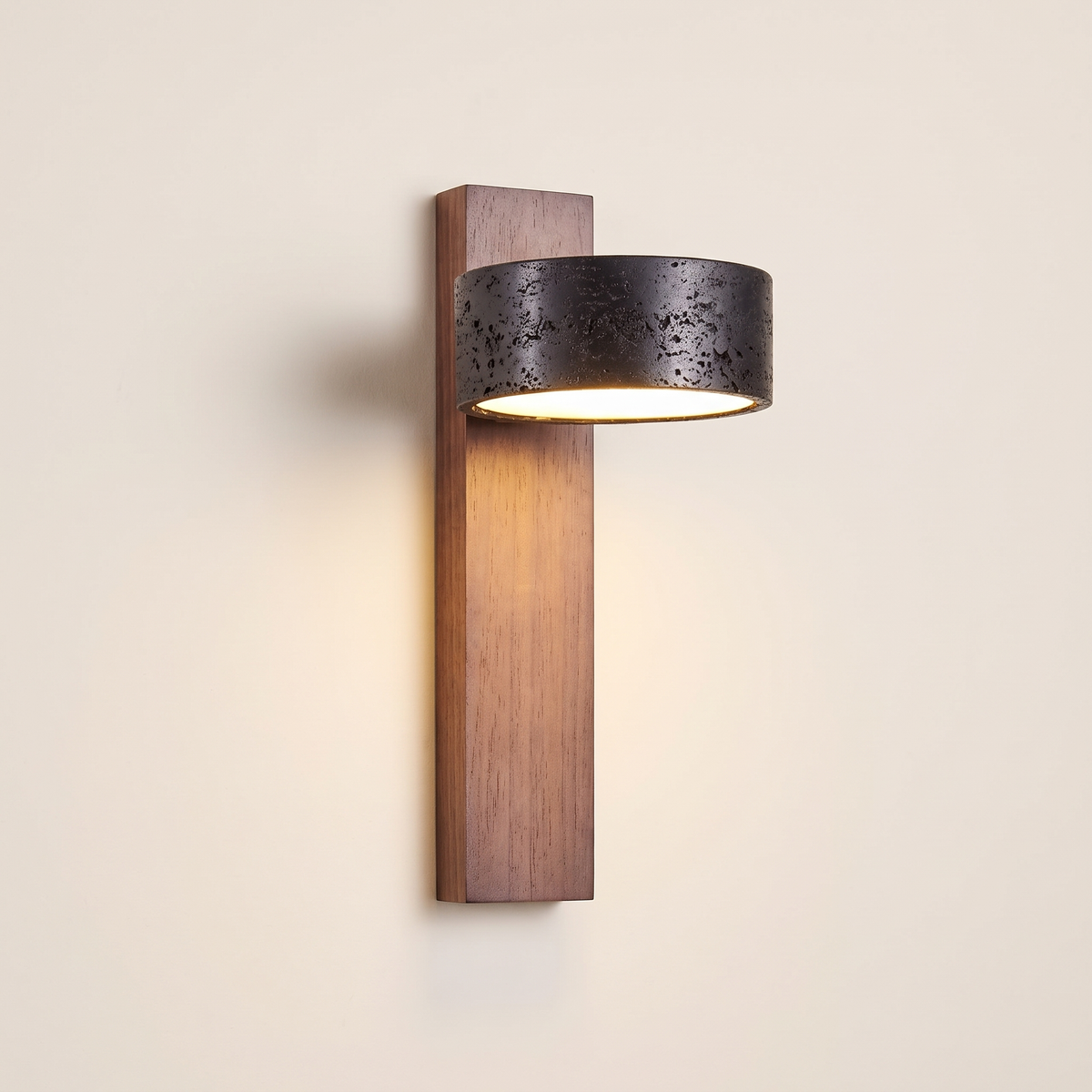 Cylvan Travertine Wall Light with a black travertine ring shade on a vertical walnut backplate