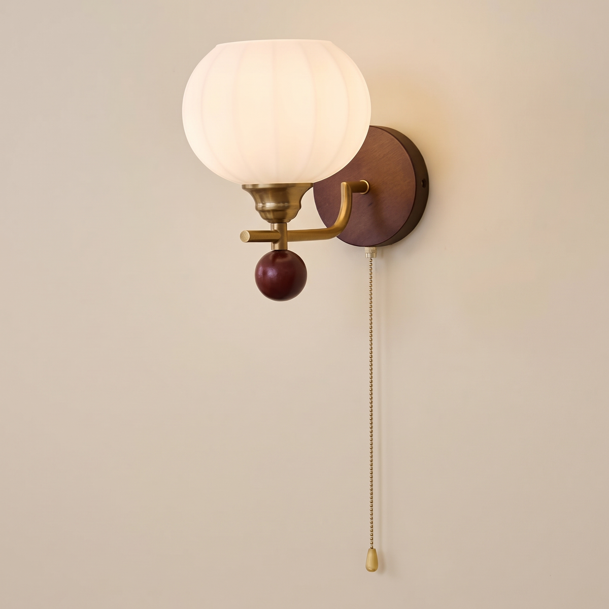 Luncrest Globe Wall Light with a ribbed white glass globe, brass arm and walnut backplate
