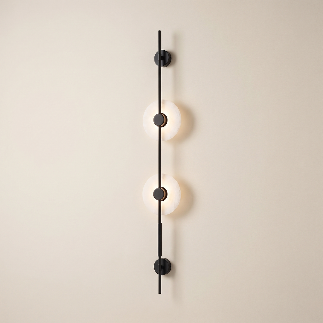 Alvessa Alabaster Disc Wall Light: tall slim vertical matte black rod wall light with 2 round glowing white alabaster discs with black centre caps along the rod and a small black round mount at each end