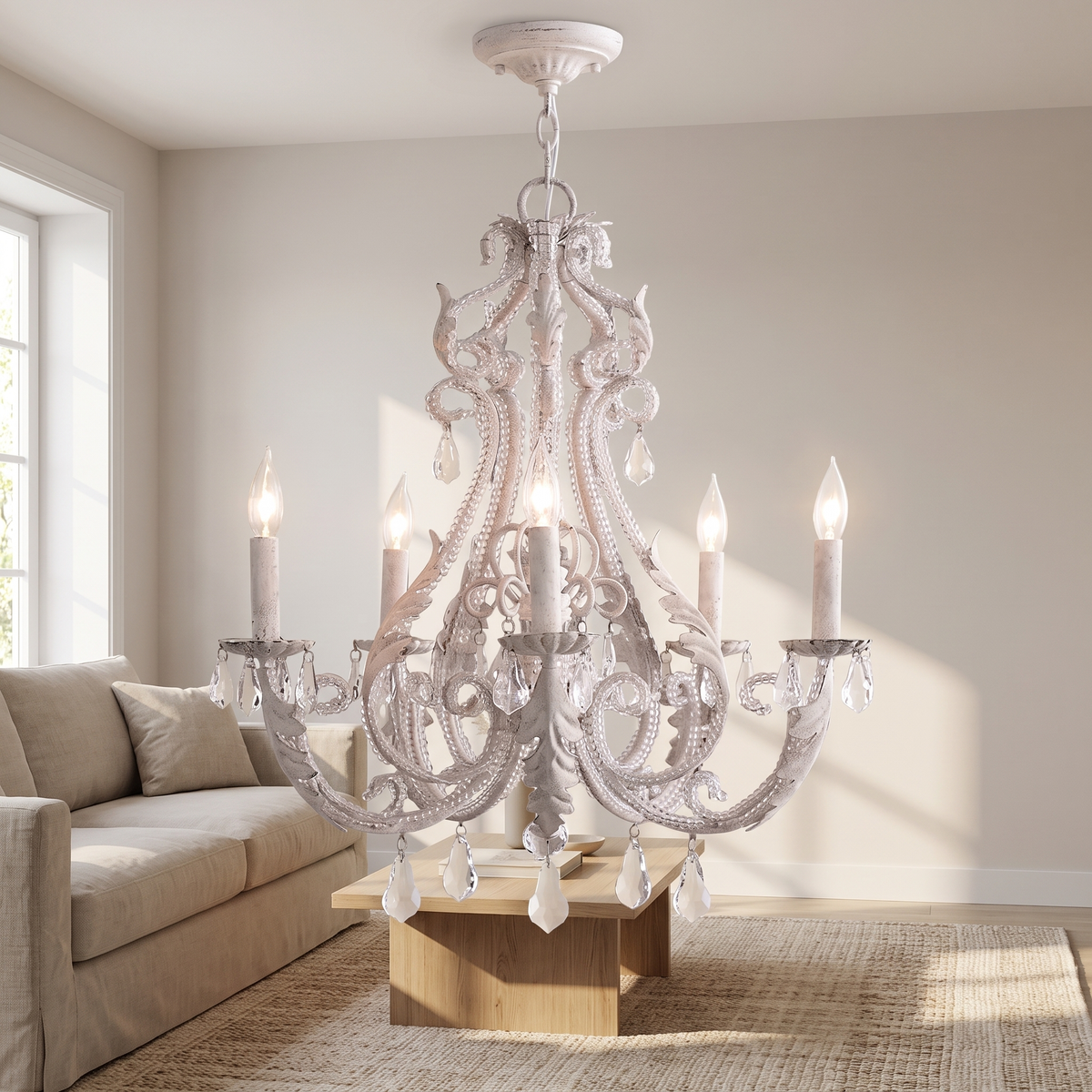 Scrollane Beaded Crystal Chandelier: vintage distressed white ornate scroll chandelier with 5 candle-style arms and hanging clear crystal drops, on a white chain, shown in a living room