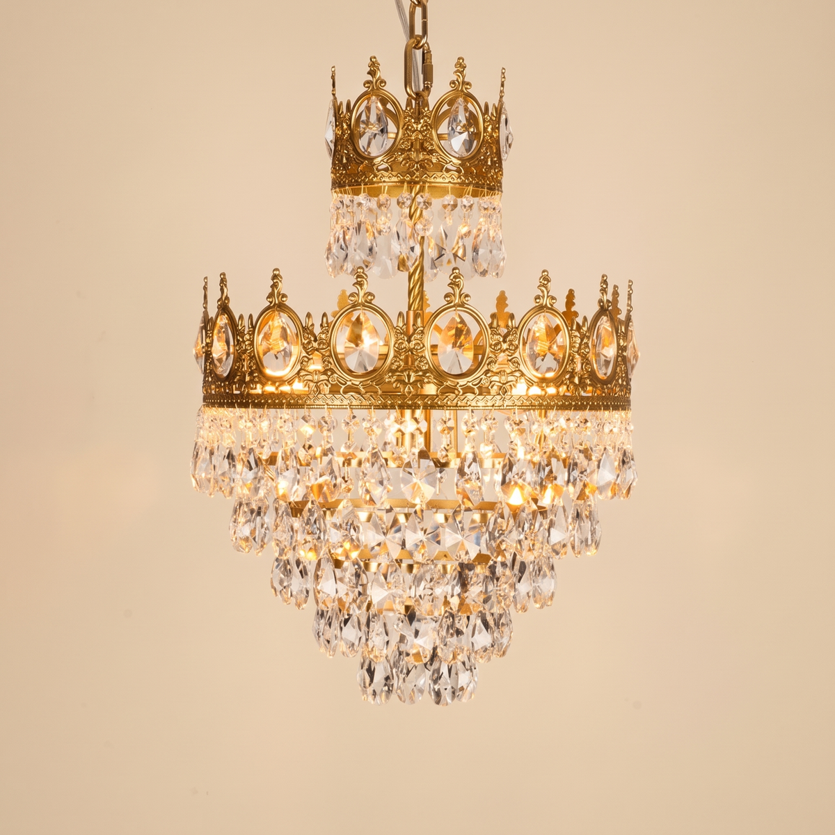 Regalette Crowned Crystal Chandelier: gold crown-style chandelier: 2 ornate gold crown bands set with round jewel accents and tiers of clear crystal drops, on a gold chain