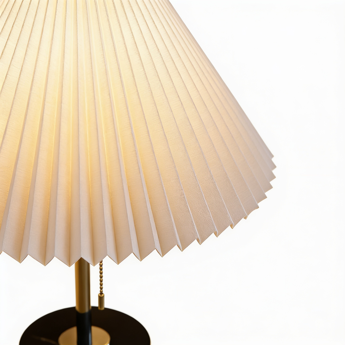 Mathella Table Lamp close-up of the cream pleated shade, brass stem and pull chain